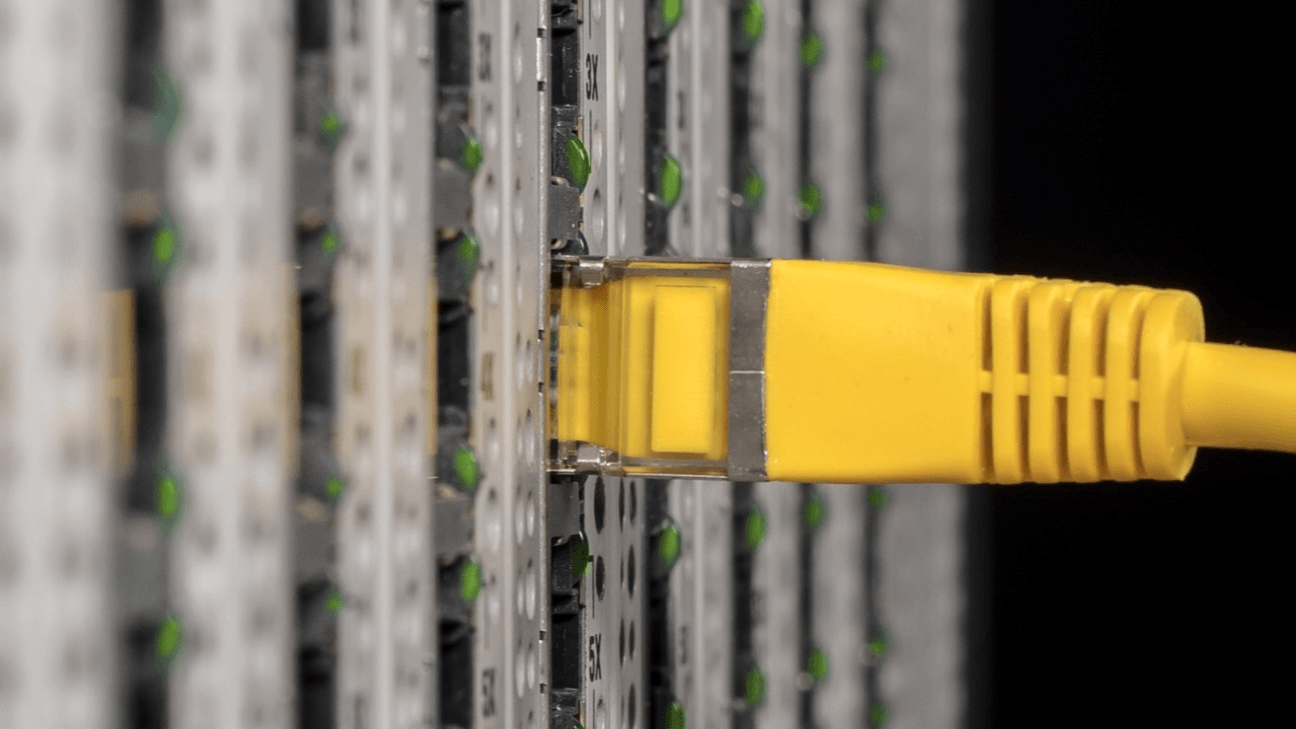 A yellow cable plugging into a server