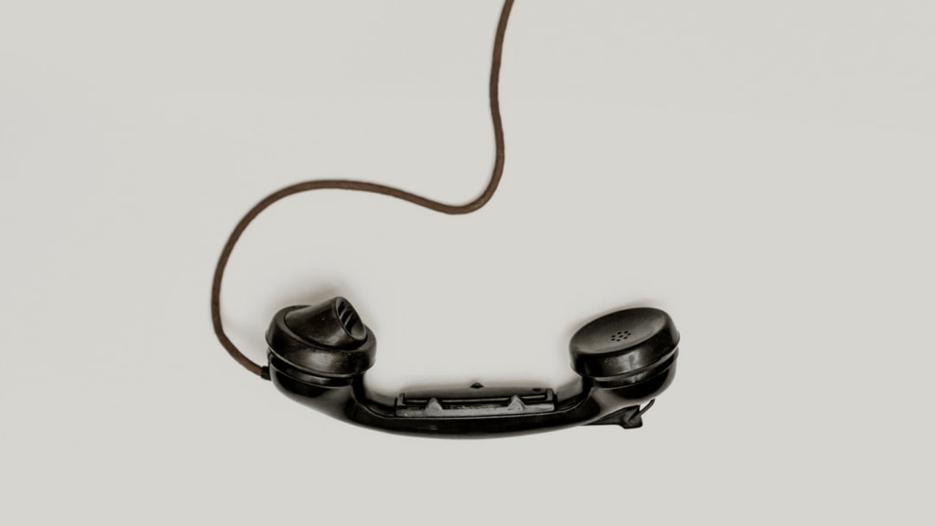 A old telephone hanging by the cord